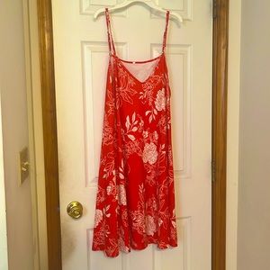 Red and white flowered summer dress. Has pockets! Falls right above the knee.
